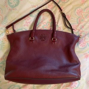 Tory Burch burgundy satchel with braided handles and crossbody strap.